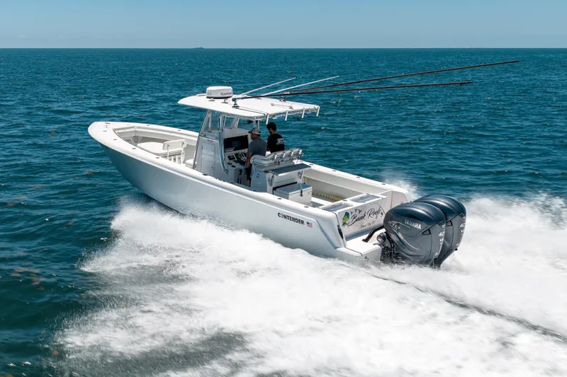 Slide: The Image of 2022 Contender 35 ST boat cruising on open ocean with dual Yamaha engines. - 5