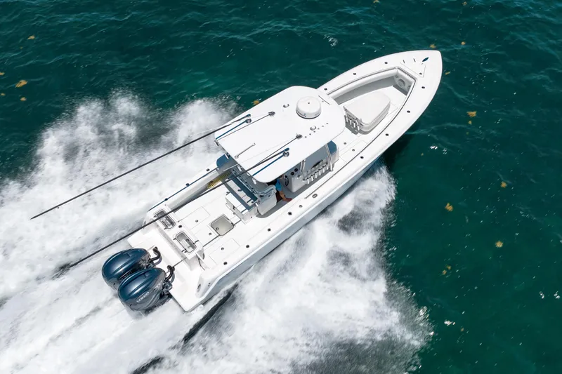 Slide: The Image of 2022 Contender 35 ST boat cruising on clear blue ocean waters. - 7