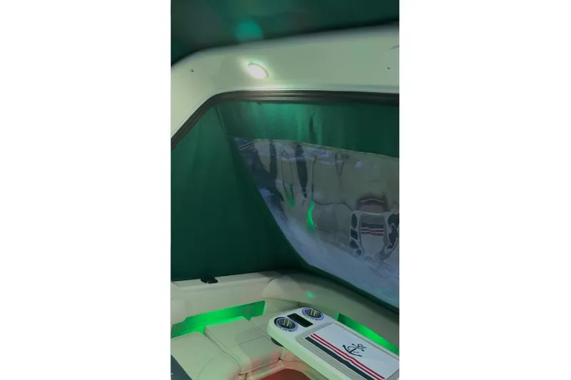 Slide: The Image of Interior of 1994 Sea Ray 300 Sundancer with green canopy and seating area. - 10