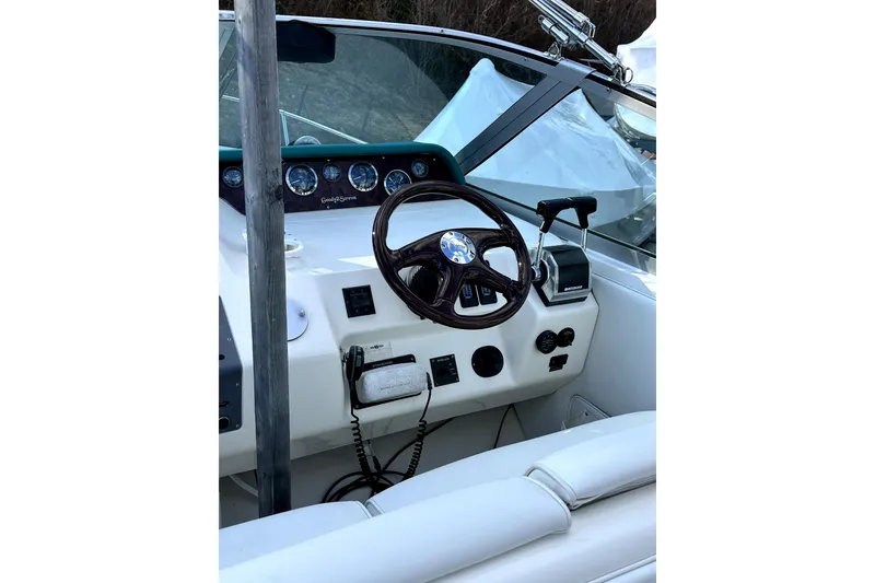 Slide: The Image of Cockpit of 1994 Sea Ray 300 Sundancer with steering wheel and control panel. - 9