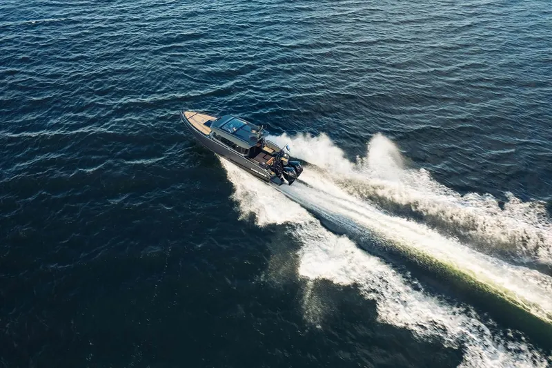 Slide: The Image of Aerial view of 2027 XO EXPLR 10 Sport Plus speeding on open water. - 3