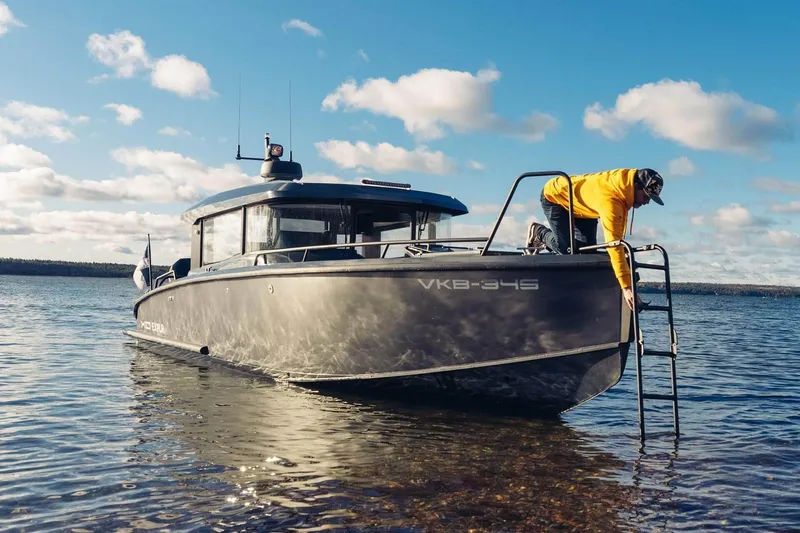 Slide: The Image of 2027 XO EXPLR 10 Sport Plus boat on water with person in yellow jacket. - 7