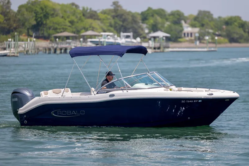 The Image of 2024 Robalo R207 Dual Console boat cruising on a sunny day. - 1