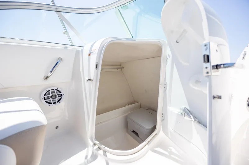 Slide: The Image of 2024 Robalo R207 Dual Console boat interior with storage compartment and speaker. - 12