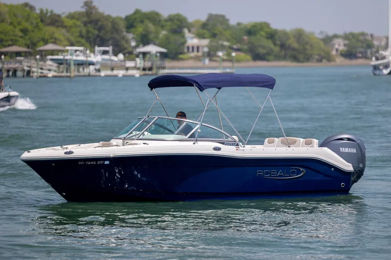 Slide: The Image of 2024 Robalo R207 Dual Console boat on water with Yamaha engine. - 5