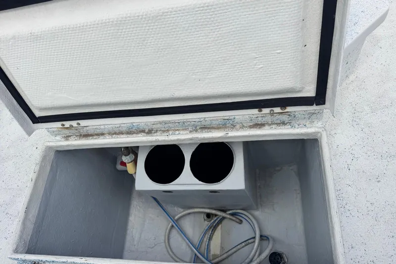 Slide: The Image of Open storage compartment on a 2008 Force Marine Force 21 boat, showing interior details. - 10
