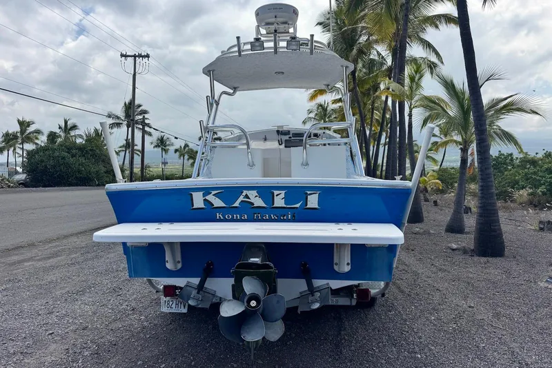 Slide: The Image of 2008 Force Marine Force 21 boat named "Kali" in Kona, Hawaii, parked near palm trees. - 4