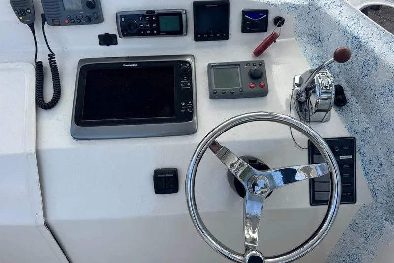 Slide: The Image of Control panel of a 2008 Force Marine Force 21 boat with steering wheel and navigation equipment. - 7
