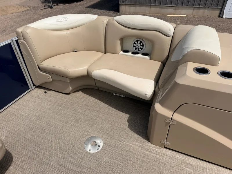 Slide: The Image of Interior of Sylvan Mirage 8524 LE pontoon boat, beige seating, speaker. - 12