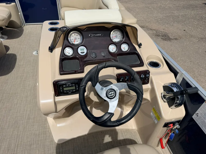 Slide: The Image of Steering console of a 2016 Sylvan Mirage 8524 LE boat. - 23