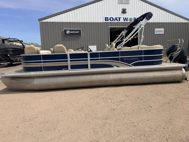 Slide: The Image of 2016 Sylvan Mirage pontoon boat outside boat workshop. - 32