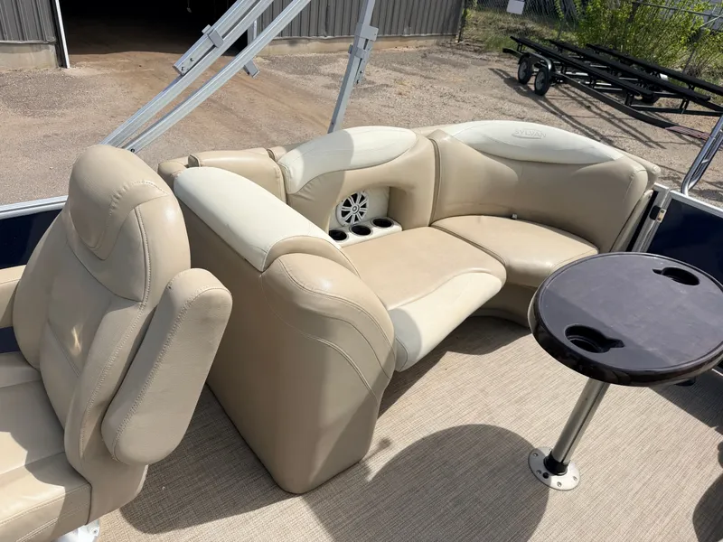 Slide: The Image of Interior of Sylvan Mirage 8524 LE pontoon boat, beige leather seats, table. - 37