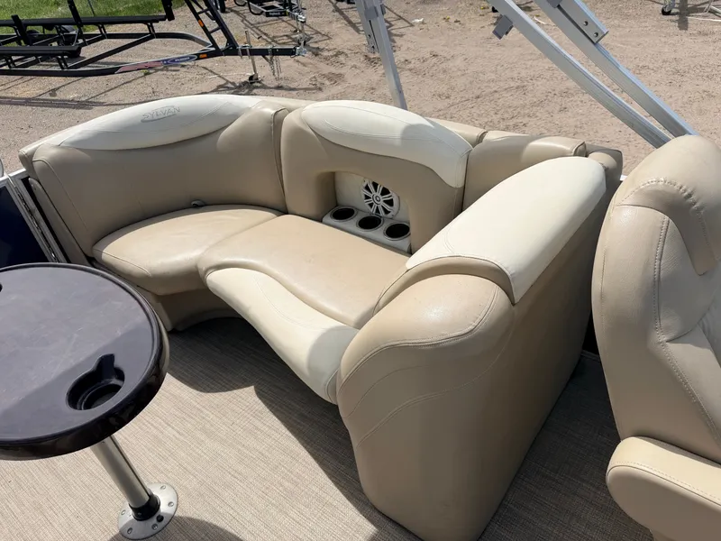 Slide: The Image of 2016 Sylvan Mirage 8524 LE interior with beige seating and table. - 39