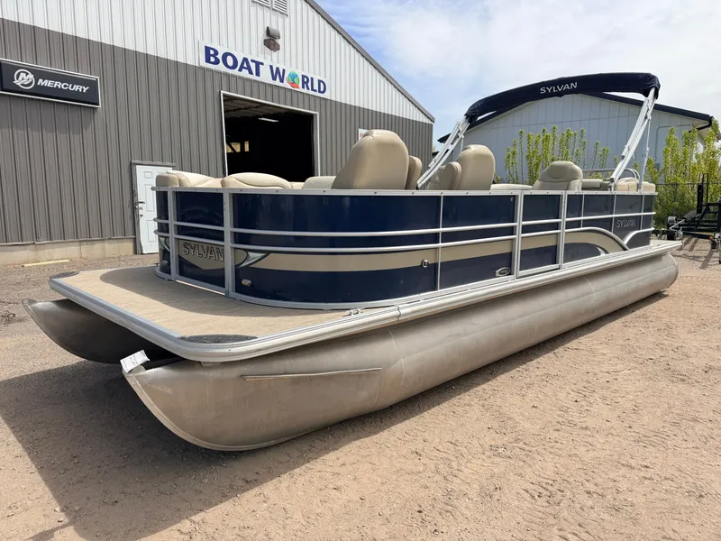 Slide: The Image of 2016 Sylvan Mirage pontoon boat outside Boat World building. - 47