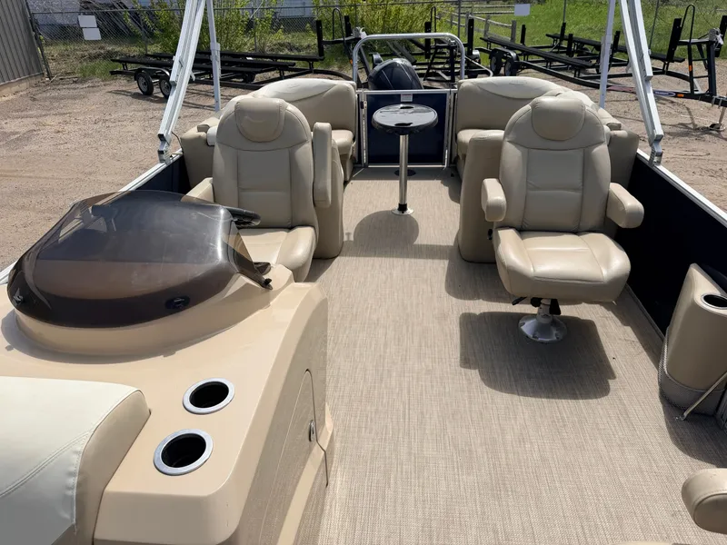 Slide: The Image of 2016 Sylvan Mirage 8524 LE pontoon boat interior, beige seats, table. - 5