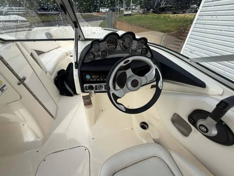 Slide: The Image of Interior view of a 2009 Bayliner 225 BR boat with steering console. - 11