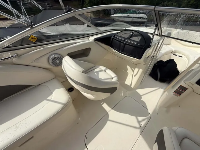 Slide: The Image of Interior of a 2009 Bayliner 225 BR boat with white seating. - 12
