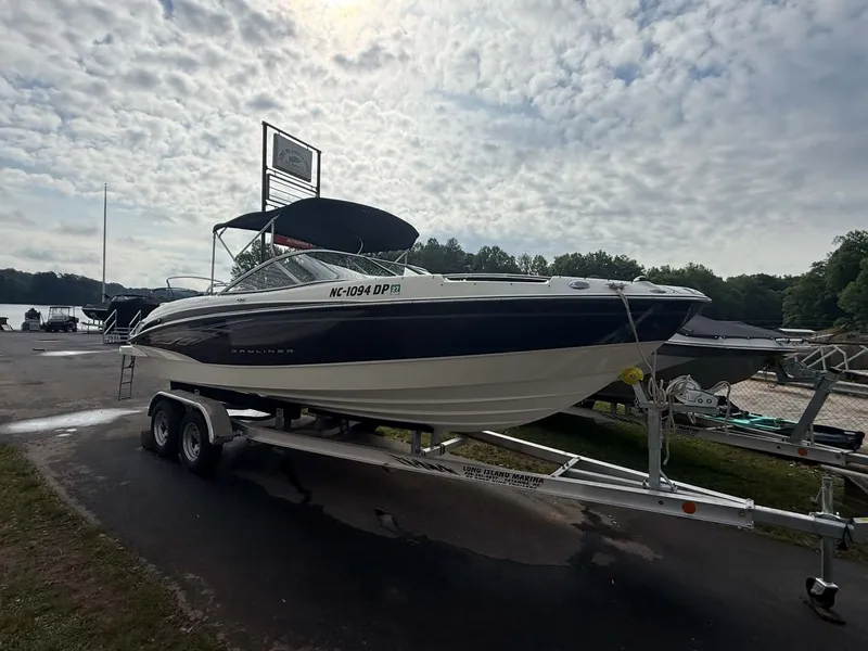 Slide: The Image of 2009 Bayliner 225 BR boat on trailer by lakeside. - 16