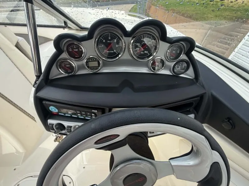 Slide: The Image of Dashboard of a 2009 Bayliner 225 BR boat with steering wheel. - 18