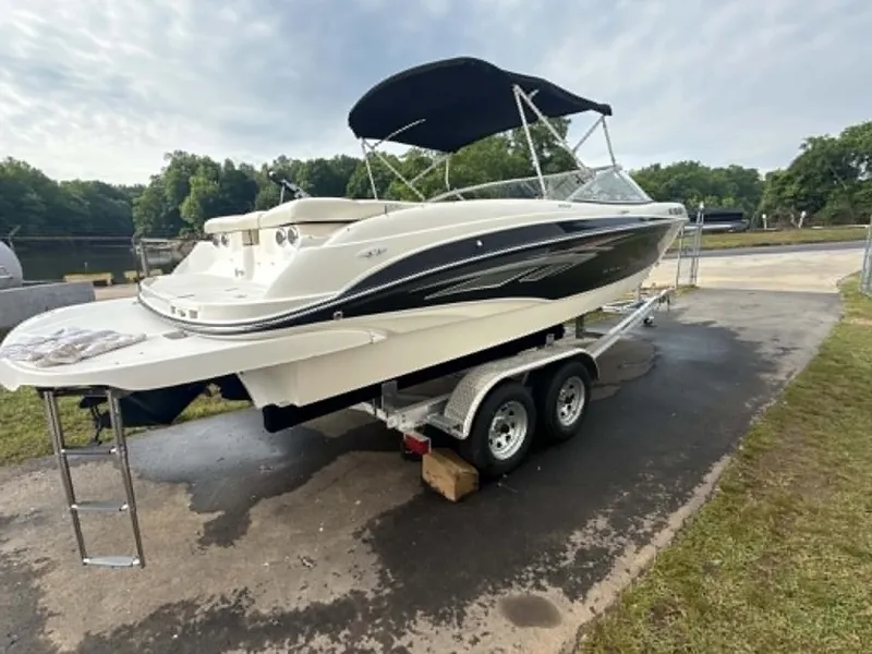 Slide: The Image of 2009 Bayliner 225 BR boat on trailer outdoors. - 19
