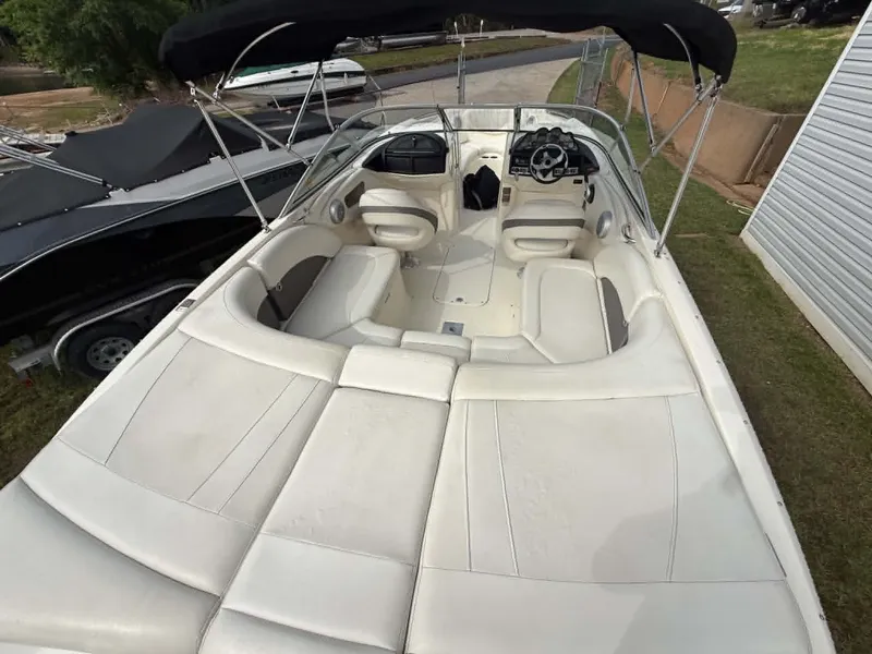 Slide: The Image of Interior view of a 2009 Bayliner 225 BR boat with white seating. - 2