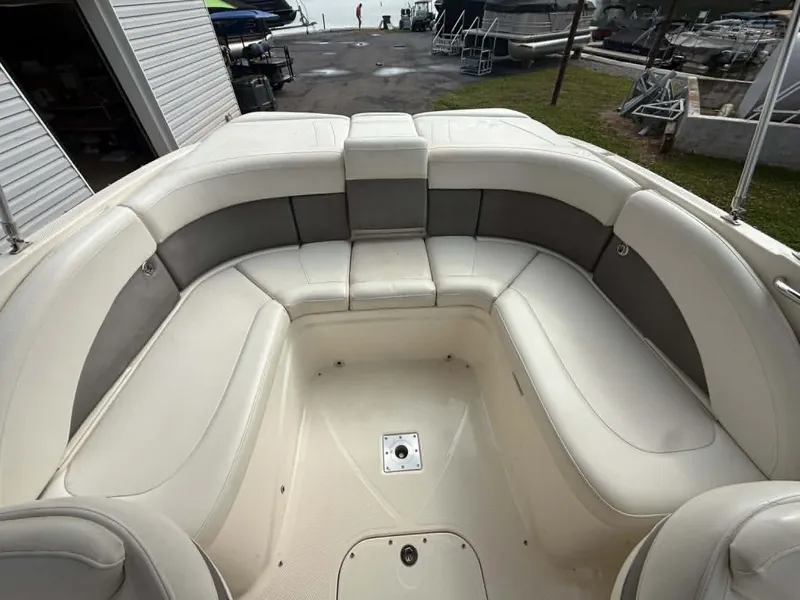 Slide: The Image of Interior of a 2009 Bayliner 225 BR boat with white upholstery. - 20