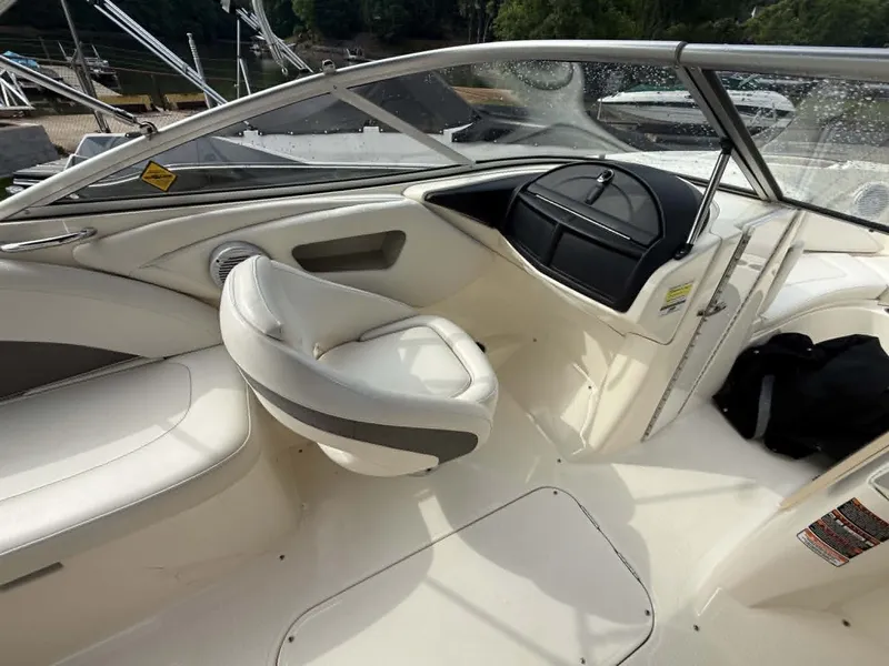 Slide: The Image of Interior of a 2009 Bayliner 225 BR boat with seating and helm console. - 23
