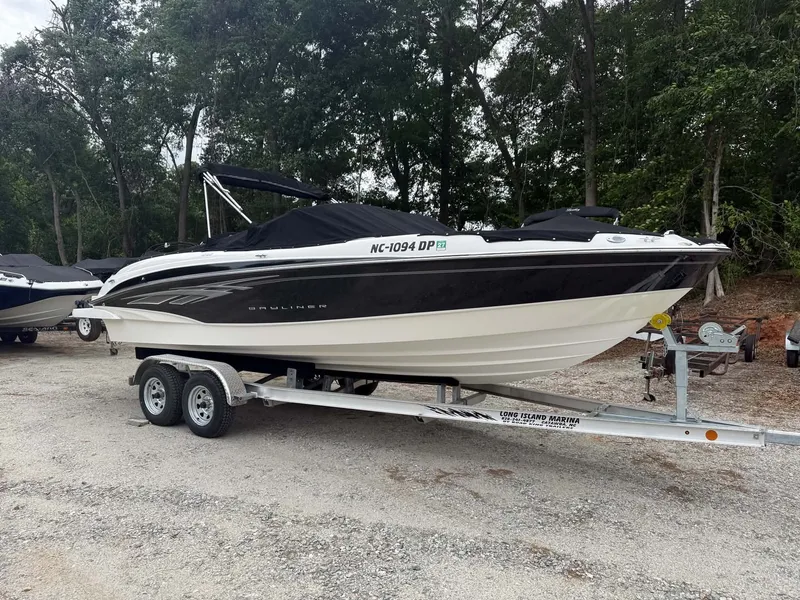 Slide: The Image of 2009 Bayliner 225 BR boat parked on trailer outdoors. - 3