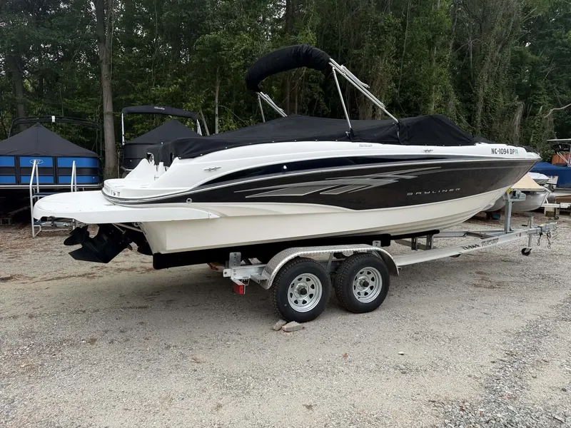 Slide: The Image of 2009 Bayliner 225 BR boat parked on trailer outdoors. - 5