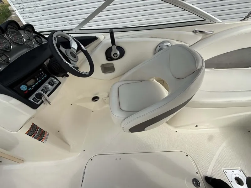 Slide: The Image of Interior of a 2009 Bayliner 225 BR boat with steering console. - 9