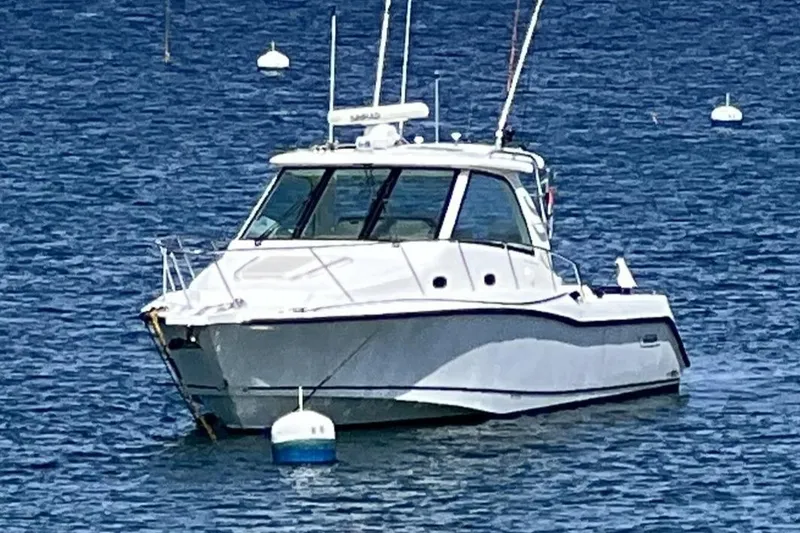 The Image of 2009 Boston Whaler 345 Conquest boat anchored on calm blue water. - 0