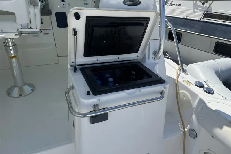 Slide: The Image of 2009 Boston Whaler 345 Conquest boat interior with open storage compartment. - 10