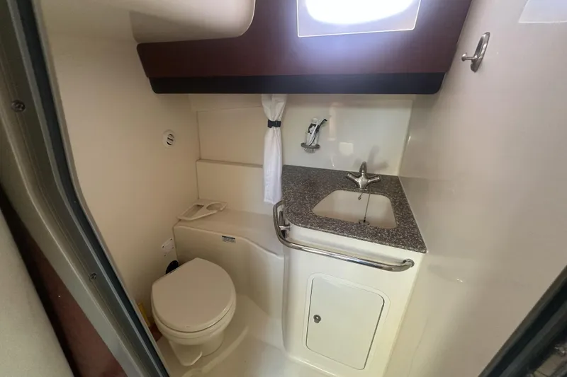 Slide: The Image of 2009 Boston Whaler 345 Conquest bathroom with sink, toilet, and window. - 13