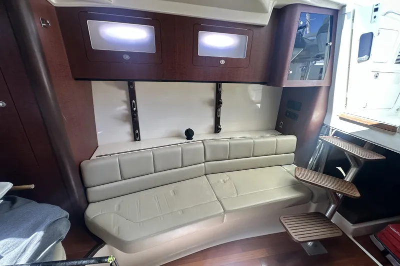 Slide: The Image of Interior of 2009 Boston Whaler 345 Conquest with beige seating and wooden accents. - 16