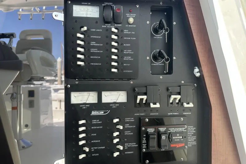 Slide: The Image of Control panel of a 2009 Boston Whaler 345 Conquest boat, featuring various switches and gauges. - 18