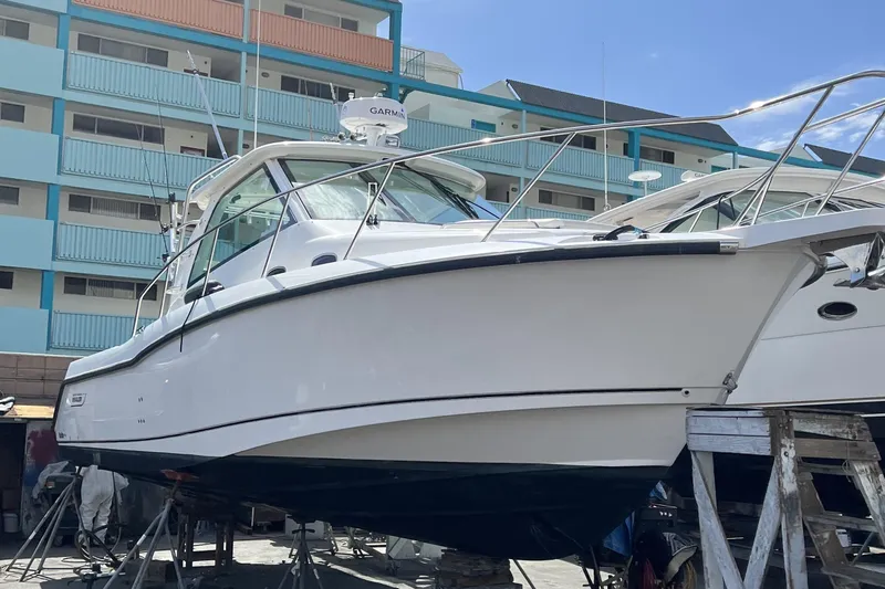 Slide: The Image of 2009 Boston Whaler 345 Conquest boat on dry dock near colorful building. - 3