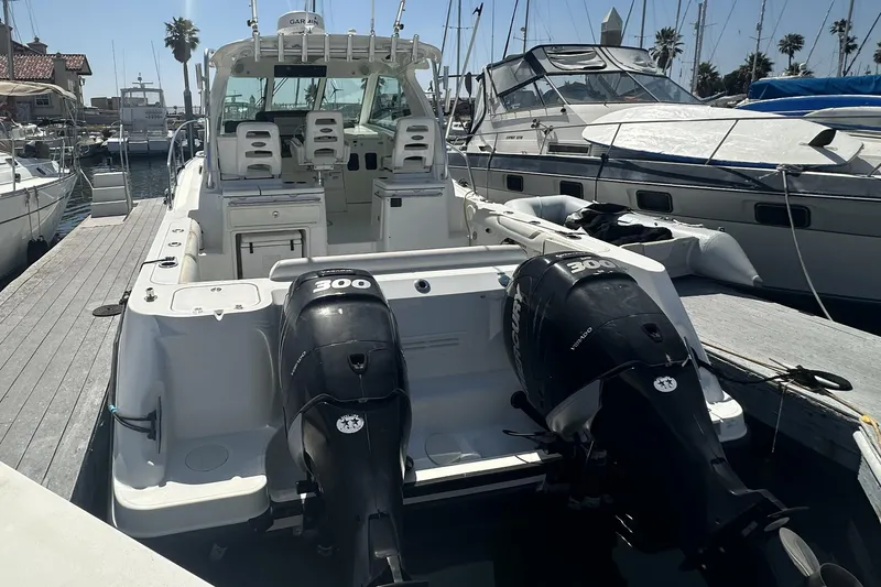 Slide: The Image of 2009 Boston Whaler 345 Conquest docked, featuring dual 300 horsepower outboard engines. - 6