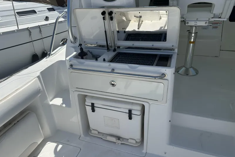Slide: The Image of 2009 Boston Whaler 345 Conquest boat interior with storage and cooler. - 9