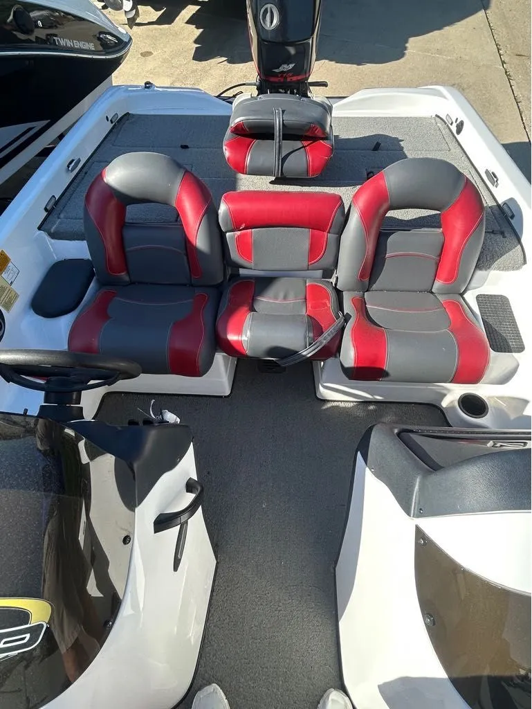 Slide: The Image of Interior of a 2005 Nitro X750 DC boat with red and gray seats. - 4