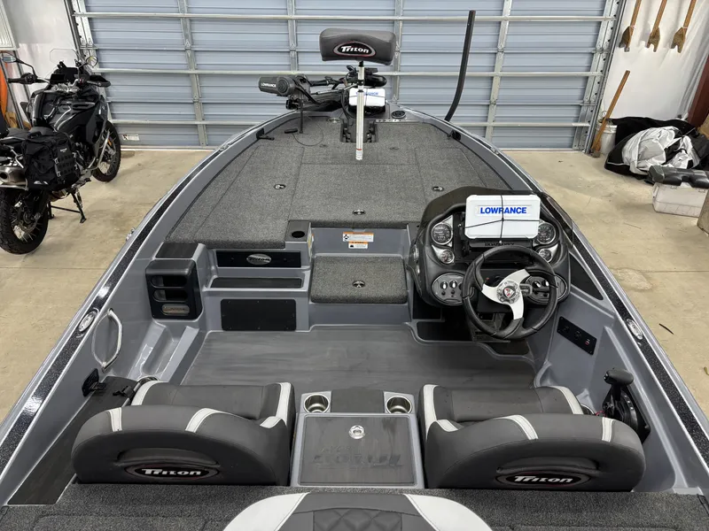 Slide: The Image of 2022 Triton 18 TrX boat with modern features in garage. - 11