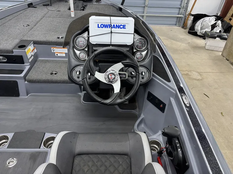 Slide: The Image of Interior view of a 2022 Triton 18 TrX boat with steering console. - 12