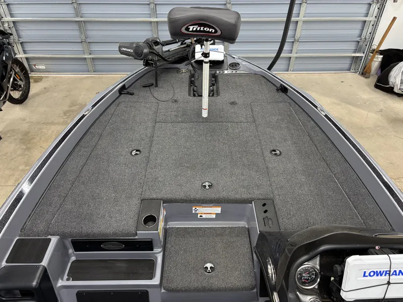 Slide: The Image of 2022 Triton 18 TrX boat with gray deck and Lowrance equipment. - 14