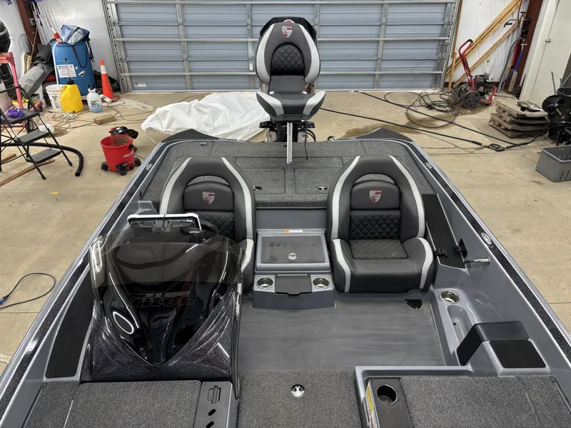 Slide: The Image of Interior view of a 2022 Triton 18 TrX boat in a garage. - 15