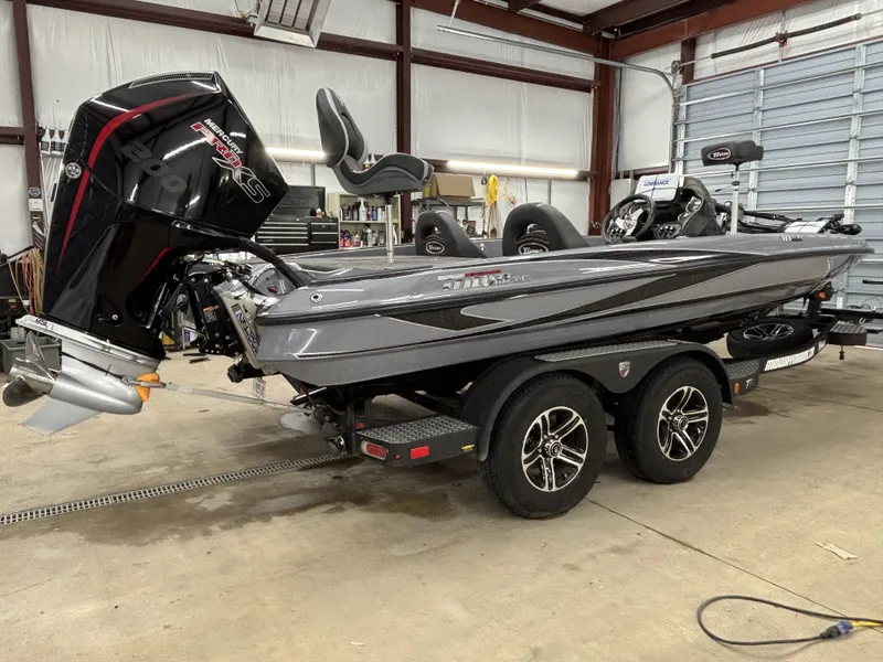 Slide: The Image of 2022 Triton 18 TrX boat parked in a garage. - 3