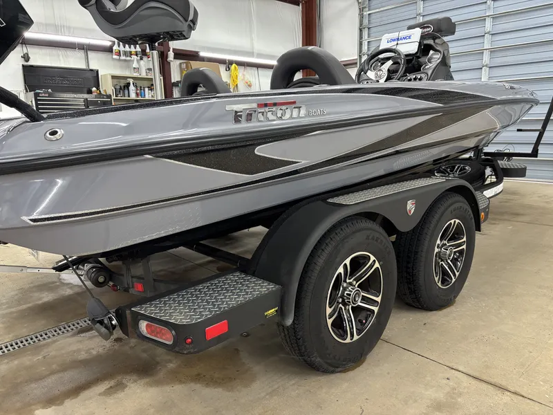 Slide: The Image of 2022 Triton 18 TrX boat on trailer in workshop. - 5