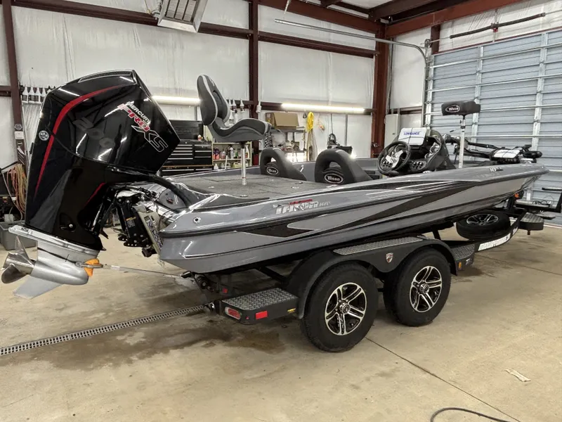 Slide: The Image of 2022 Triton 18 TrX boat parked in a garage. - 6