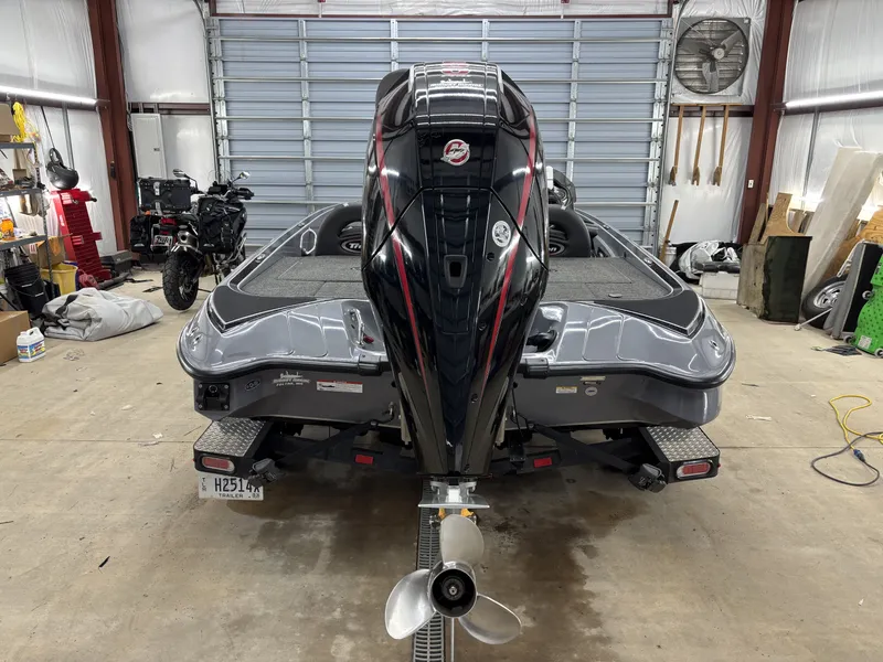 Slide: The Image of 2022 Triton 18 TrX boat parked in a garage. - 9