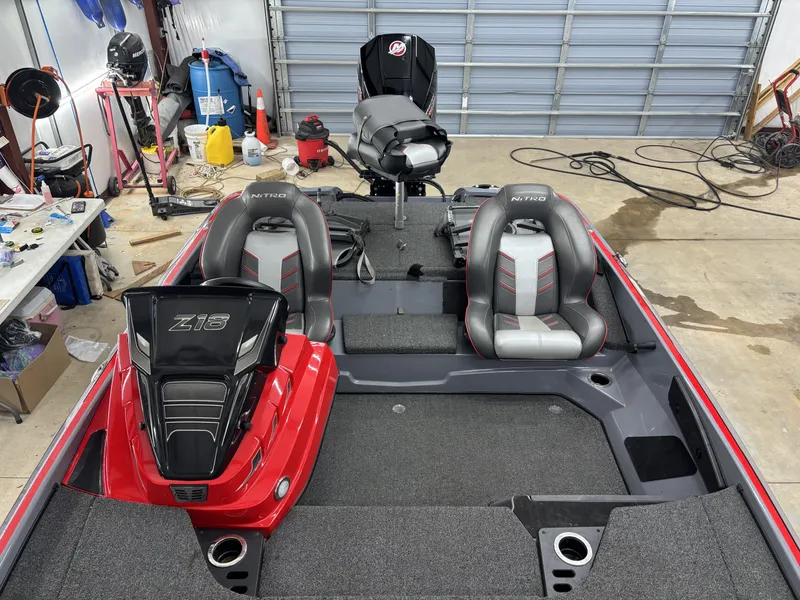 Slide: The Image of 2023 Nitro Z18 Pro boat in workshop area, gray and red seats. - 15