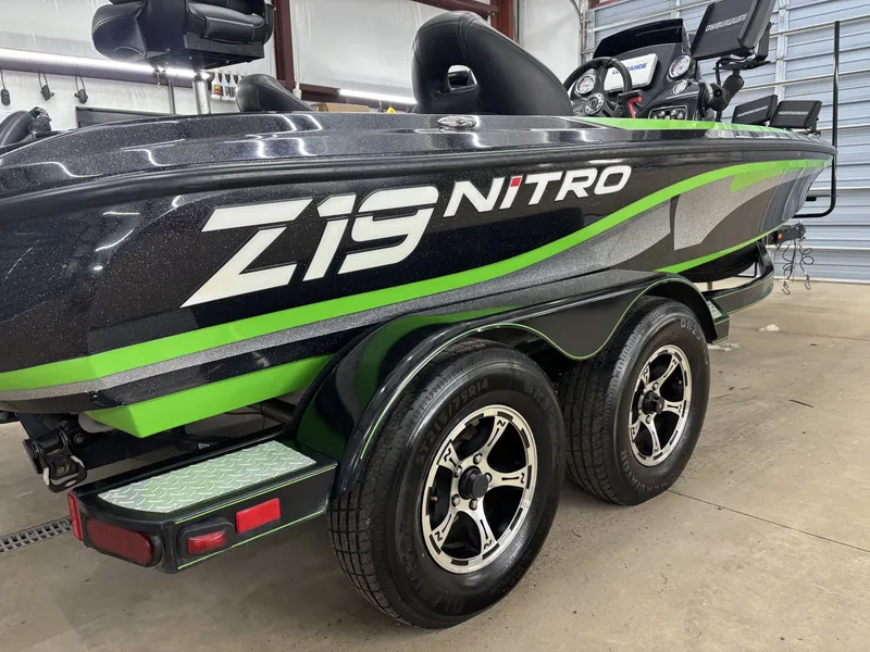 Slide: The Image of 2017 Nitro Z19 Pro boat with green accents and trailer. - 4