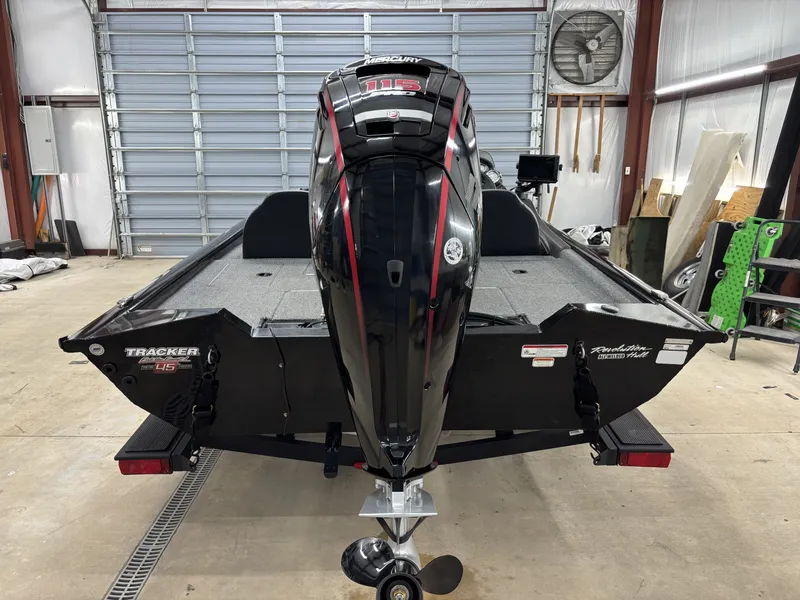 Slide: The Image of 2023 Tracker 190TX TE boat with Mercury engine in garage. - 6